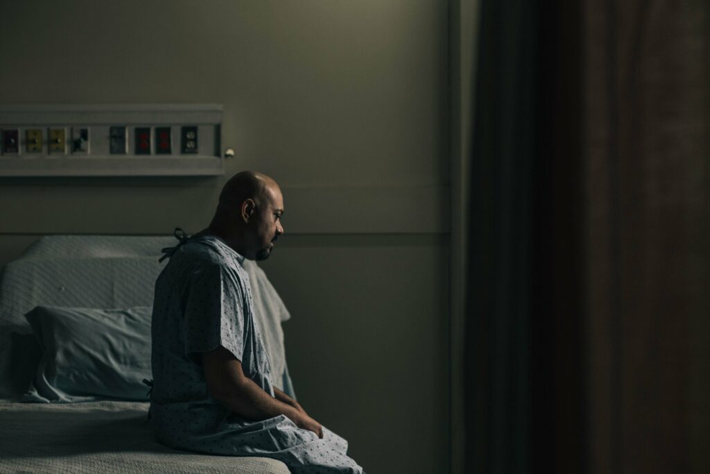 man sitting on hospital bed